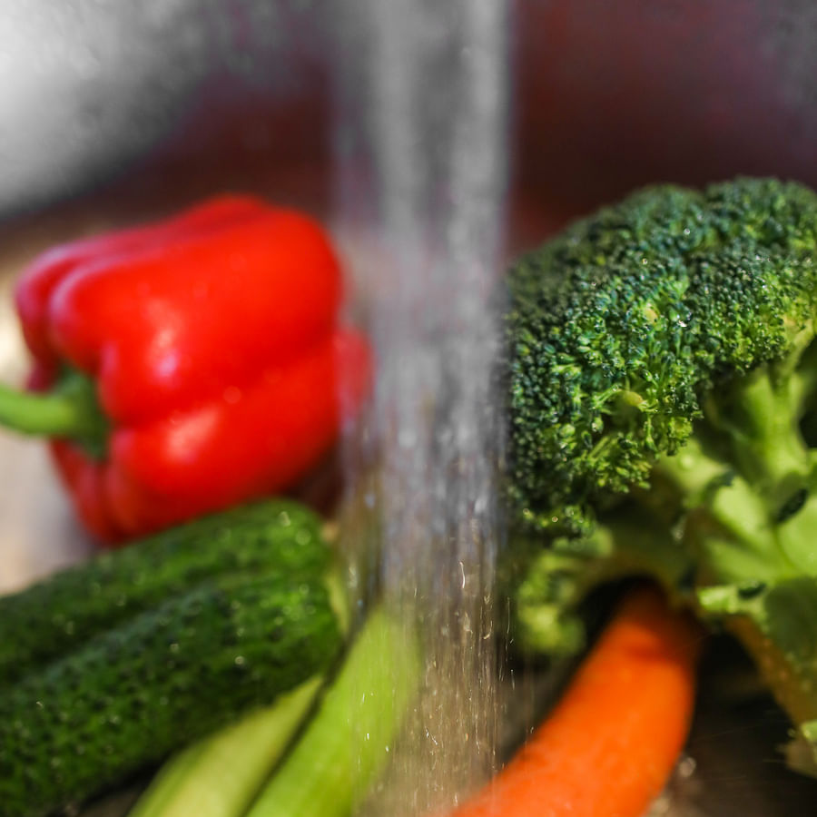 Camper cooking a one-pot vegan meal at a campsite